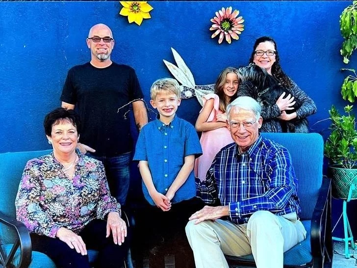 John Williams and his wife, Ann, sit for a picture with his family in Los Angeles during Thanksgiving of 2021.