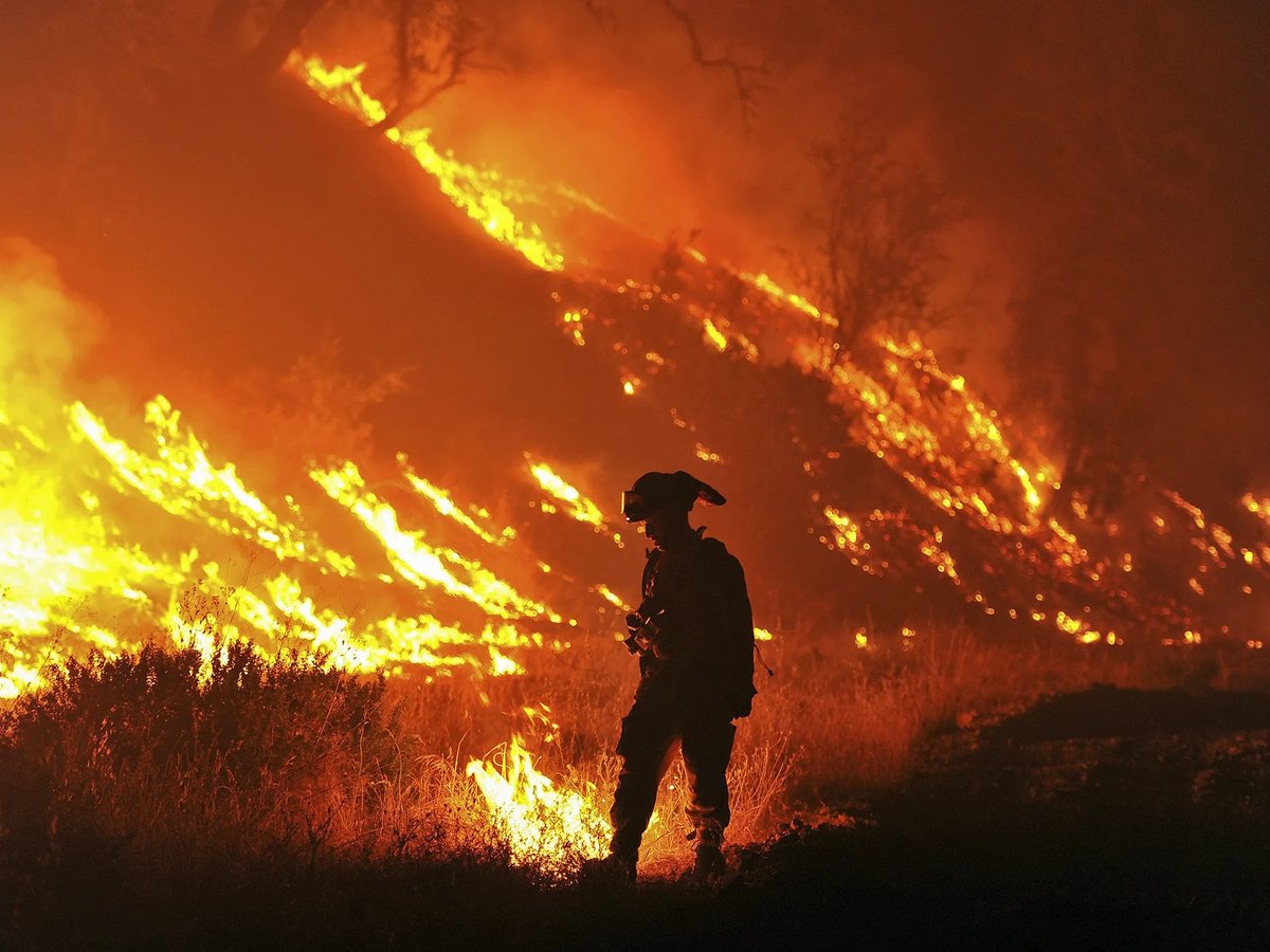 Cal Fire firefighter Bo Santiago lights a backfire as the Rocky fire burns near Clearlake in 2015.