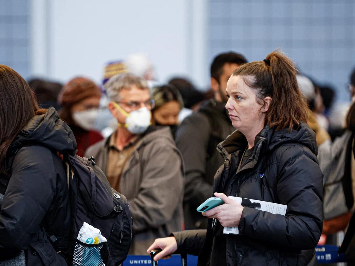 Travelers wait in line for their security screening at O'Hare International Airport on Dec. 22 in Chicago.