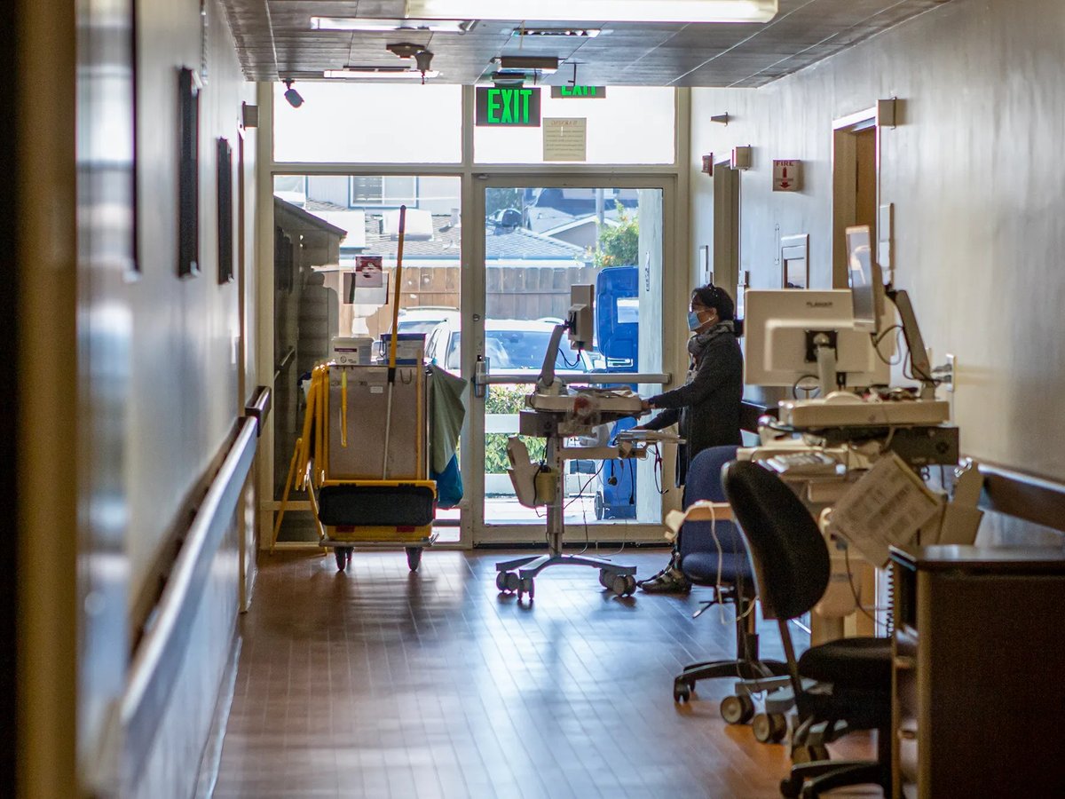A medical personnel working on her computer in the corridor of Hazel Hawkins Memorial Hospital in Hollister on March 30, 2023.