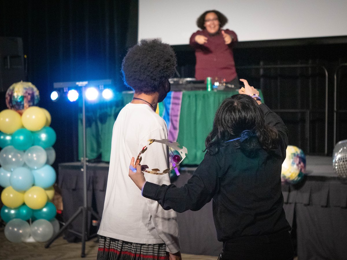 Attendees at the Rainbow Ball, held in Sacramento State's ballroom and organized by the university's PRIDE Center, dance to a song cued up by DJ and university graduate student Sage Beamon on Apr. 7, 2023.