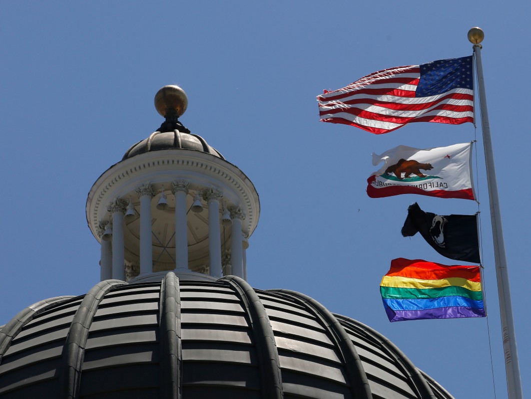 The rainbow Pride flag flutters from the flag pole at the state Capitol in Sacramento, Calif., Monday, June 17, 2019.