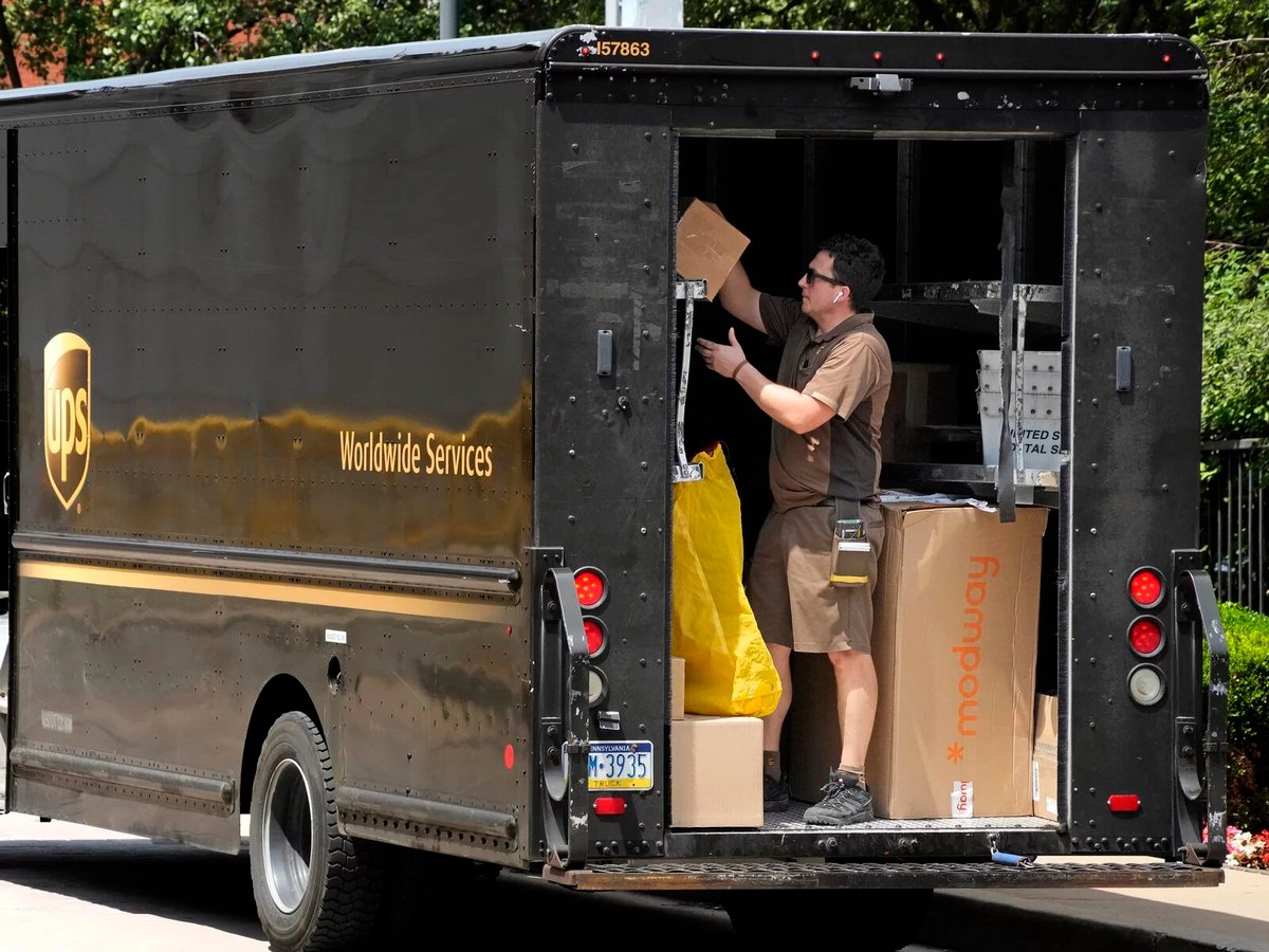 A United Parcel Service driver makes a delivery in the back of his truck in Pittsburgh, July 13, 2023.