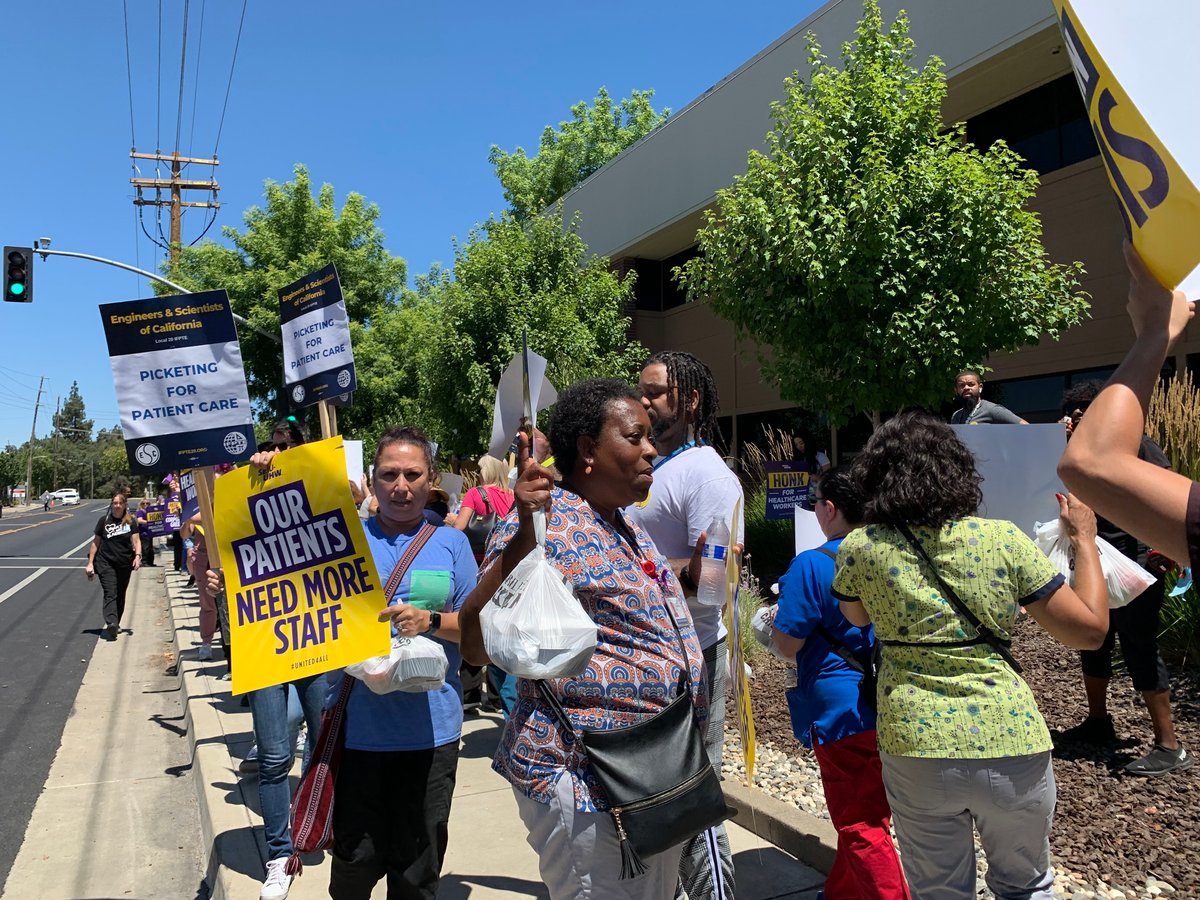 Health care workers picket on the sidewalk across from the Kaiser Permanente hospital and medical center on Morse Avenue in the Arden-Arcade area on July 25, 2023.