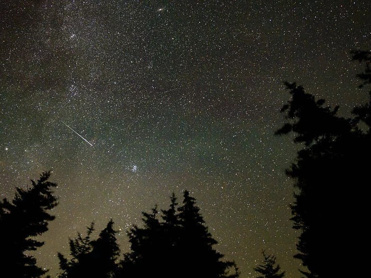 In this 30 second exposure, a meteor streaks across the sky during the annual Perseid meteor shower, Wednesday, Aug. 11, 2021, in Spruce Knob, West Virginia.