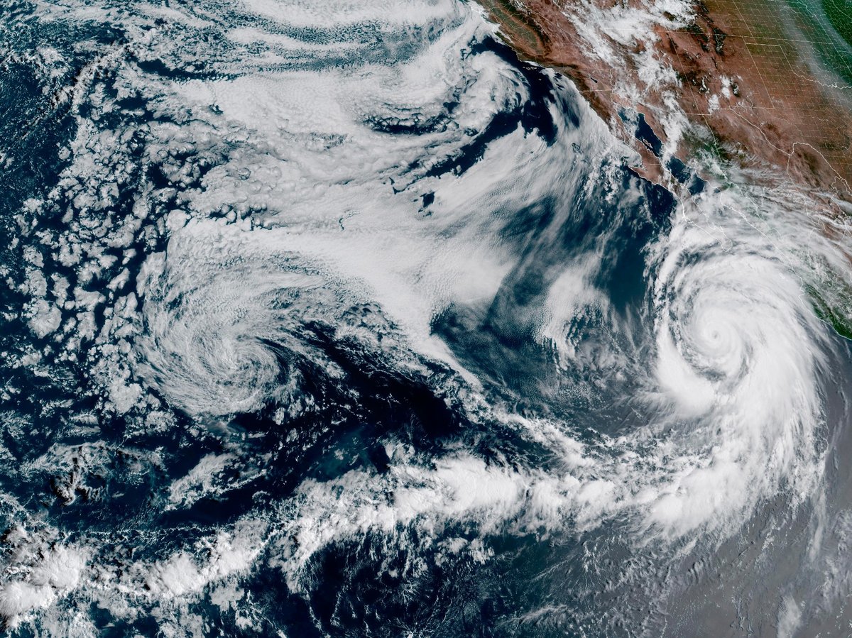 This Friday, Aug. 18, 2023, 1:10 p.m. EDT satellite image provided by the National Oceanic and Atmospheric Administration shows Hurricane Hilary, right, off Mexico’s Pacific coast.