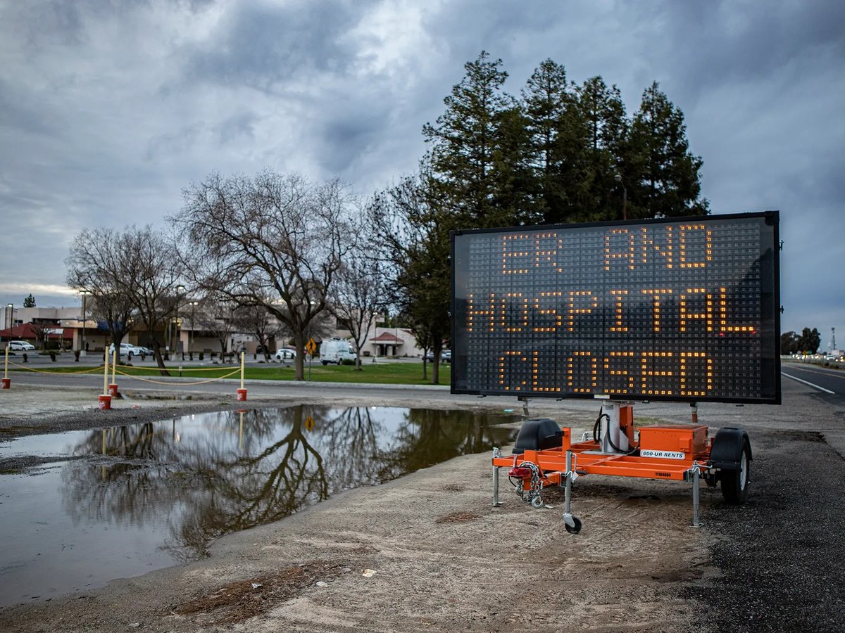A road sign announcing the closure of the emergency room and the rest of Madera Community Hospital outside the main entrance on Jan. 2, 2023.