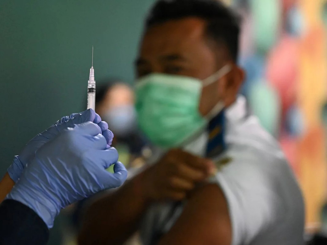 A booster vaccine is administered on the Indonesian resort island of Bali.