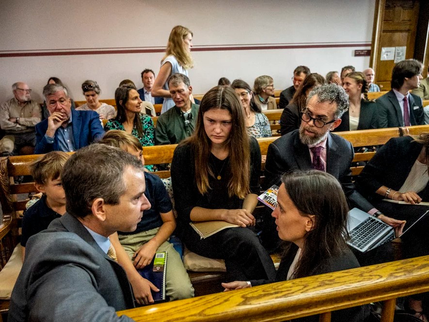 Lead claimant Rikki Held, 22, confers with members of Our Children's Trust legal team before the start of the nation's first youth climate change trial at Montana's First Judicial District Court on June 12, 2023 in Helena, Montana.