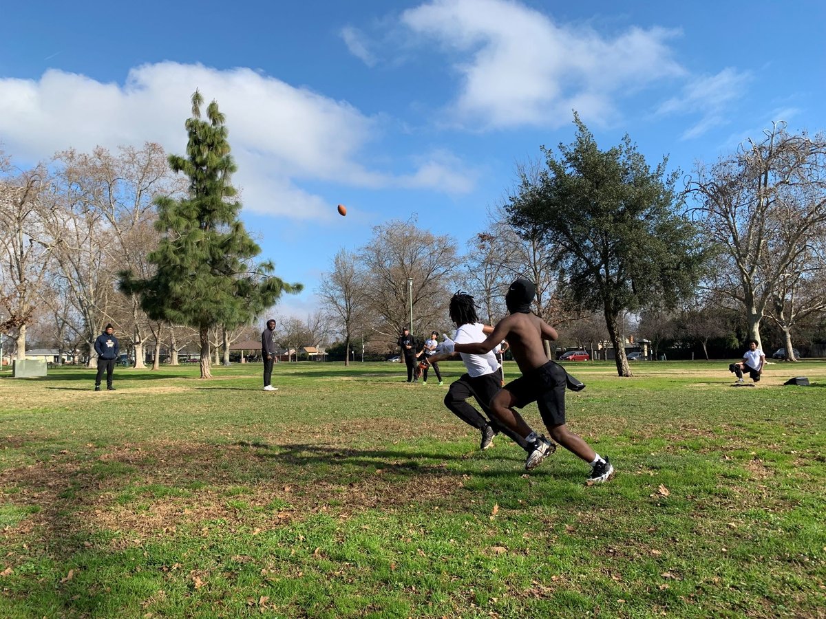 Eleven-year-old Monte Johnson and 9-year-old Waylon Parker run for the ball at a 7-on-7 practice at Tahoe Park in Sacramento on Jan. 14, 2023.