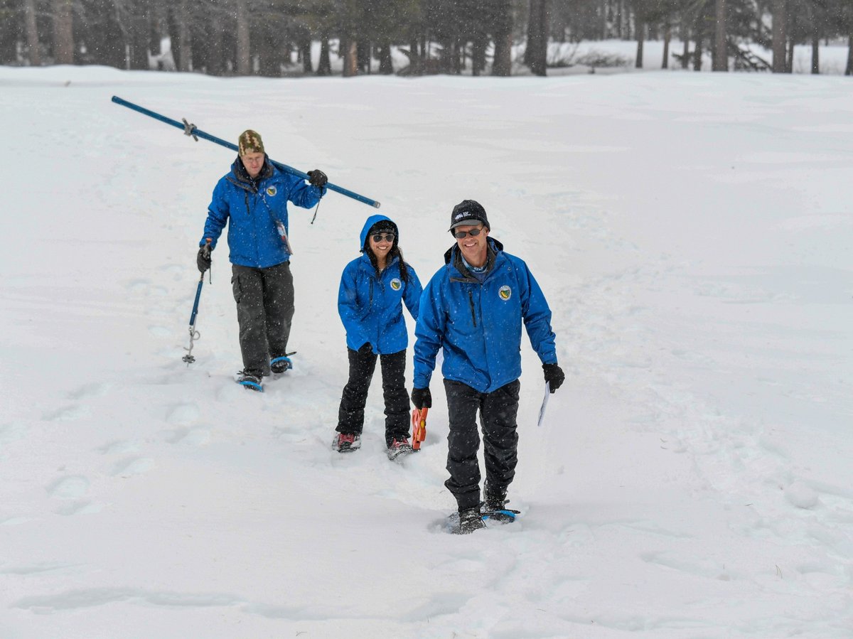 Anthony Burdock, Angelique Fabbiani-Leon and Andy Reising from the California Department of Water Resources Snow Surveys and Water Supply Forecasting Unit, walk in the deep snow during the measurement phase of the snow survey on Feb. 29, 2024.