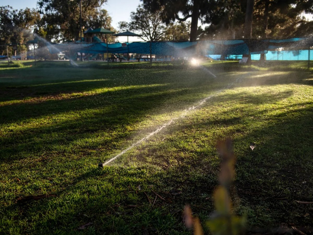 Sprinklers water a lawn in Los Angeles on June 5, 2022. Under new proposed rules, water agencies in California's urban areas will have to meet mandatory water conservation cuts.