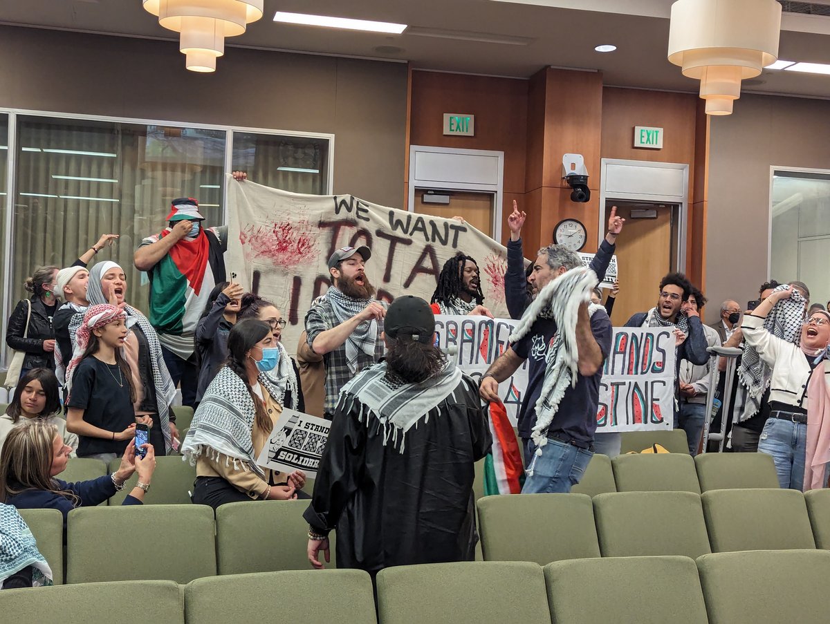 A group of people protesting at the Tuesday, March 19, 2024 Sacramento City Council meeting. Council members were on a recess from hearing public comment on a proposed resolution calling for a cease-fire in Gaza.