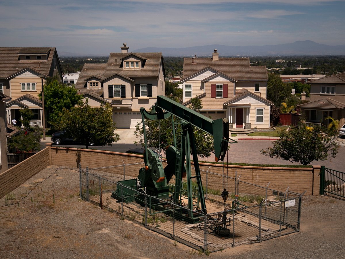 A pump jack extracts oil at a drilling site next to homes June 9, 2021, in Signal Hill, Calif.