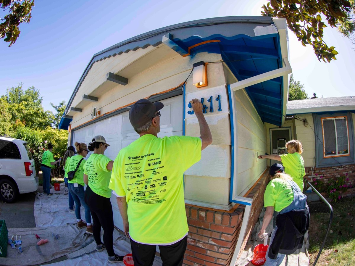 Rock the Block volunteers paint the exterior of a Bonniemae Way home in Oak Park on May 3.