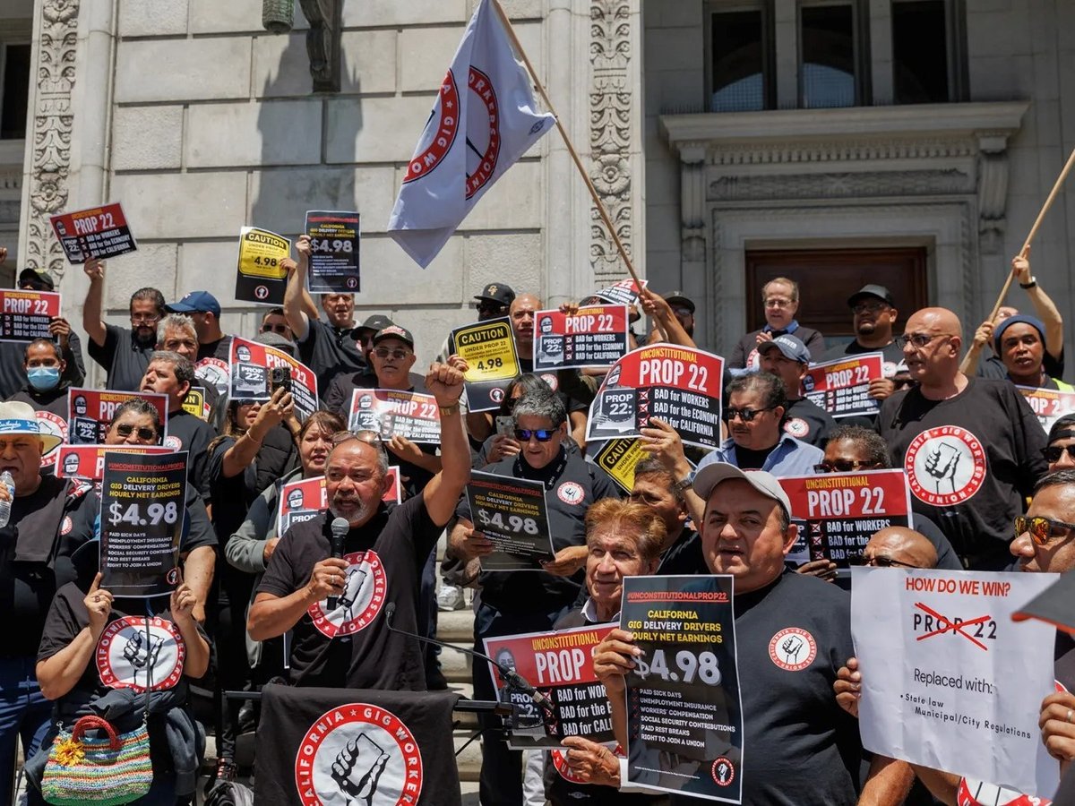 Ride-share driver and SEIU Gig Workers Union member John Mejia, center, speaks during a press conference outside of the Supreme Court of California in San Francisco on May 21, 2024.