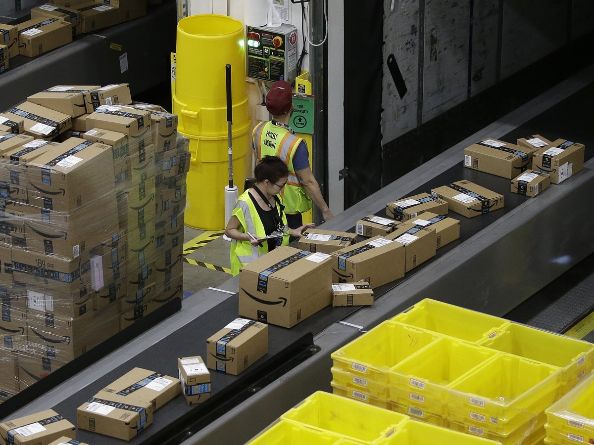 Packages move down a conveyor system were they are directed to the proper shipping area at an Amazon Fulfillment Center in Sacramento, Calif., on Feb. 9, 2018.