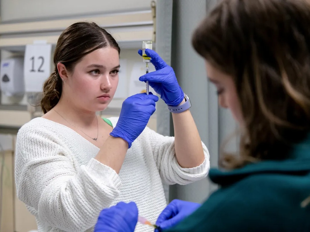 Nursing students Ashley Jensen, left, and Courtney Houtz practice injection procedures in the clinical skills lab at University of San Francisco in San Francisco, Calif. on Oct. 9, 2023. Health care is one of the areas that has added jobs since 2022.