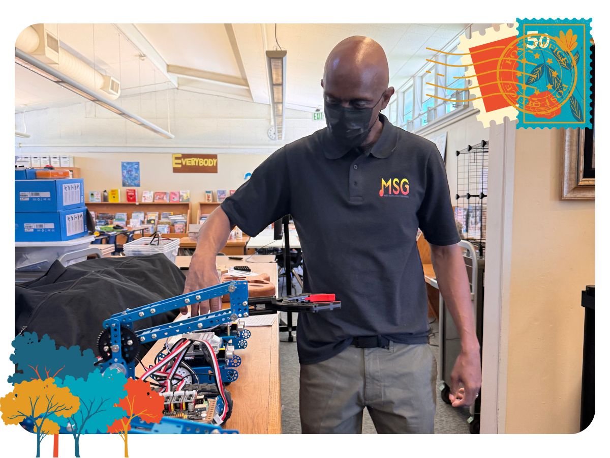Flip Kirby shows the robots that students can program at the Music Science Group at Bowling Green Elementary School.