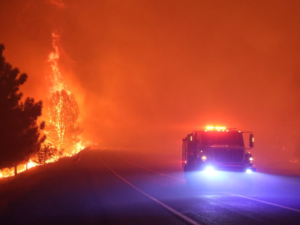 Firefighters drive through an active portion of the Park Fire in Butte County on July 26, 2024.