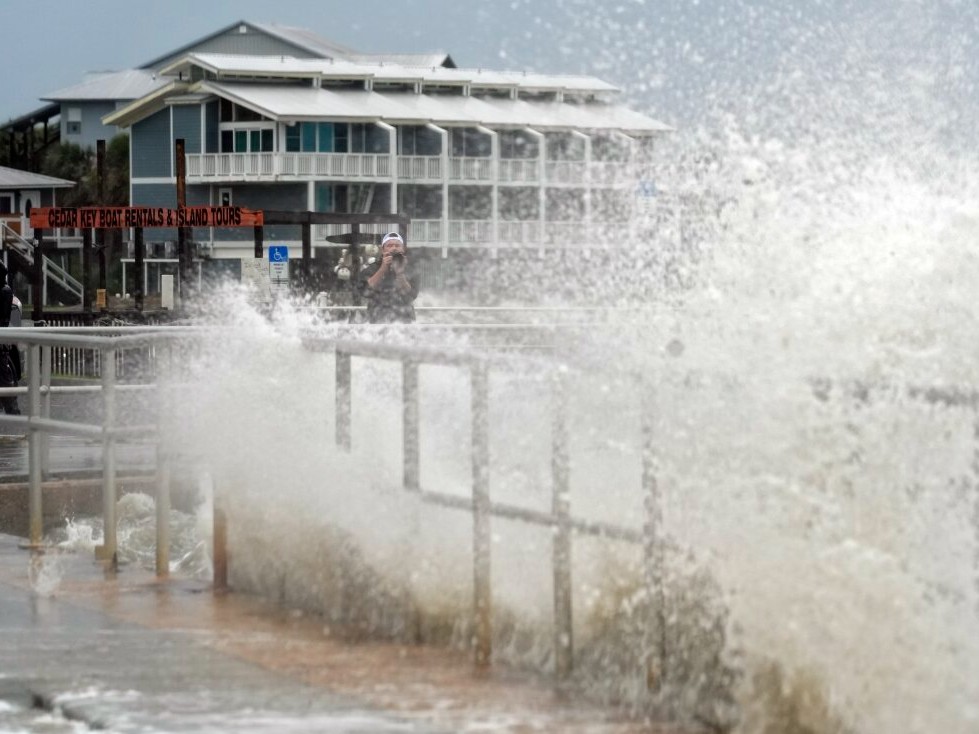 Surf from Tropical Storm Debby breaks over a sea wall in Cedar Key, Fla., in August 2024. Abnormally hot ocean water is contributing to a very active Atlantic Hurricane season.