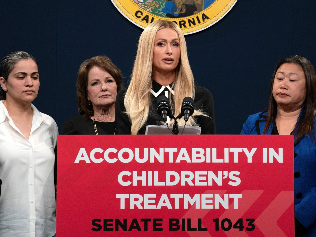 Hotel heiress and media personalty Paris Hilton, center, discusses a proposed bill calling on more transparency for youth treatment facilities during a news conference in Sacramento, Calif., Monday, April 15, 2024.