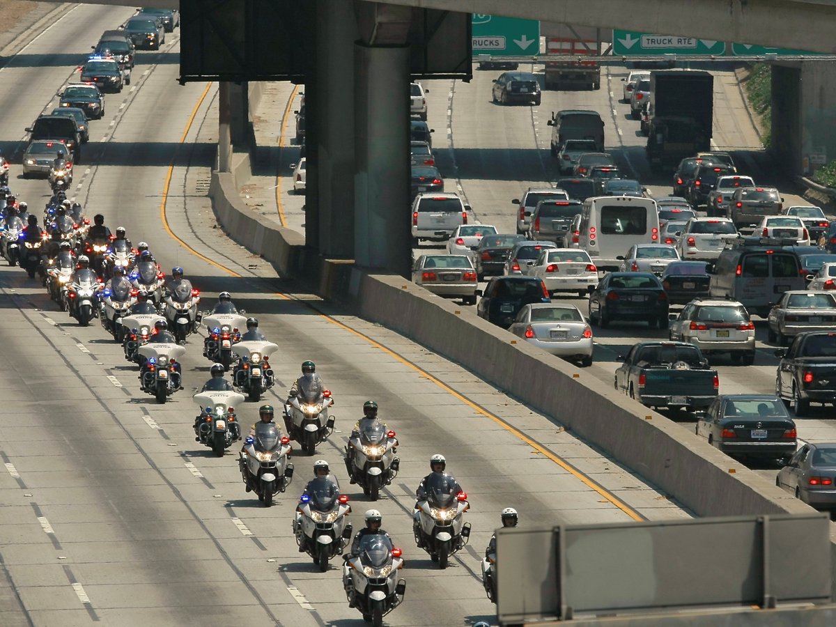 California Highway Patrol officers ride during a funeral procession on Wednesday, June 30, 2010, in Los Angeles.