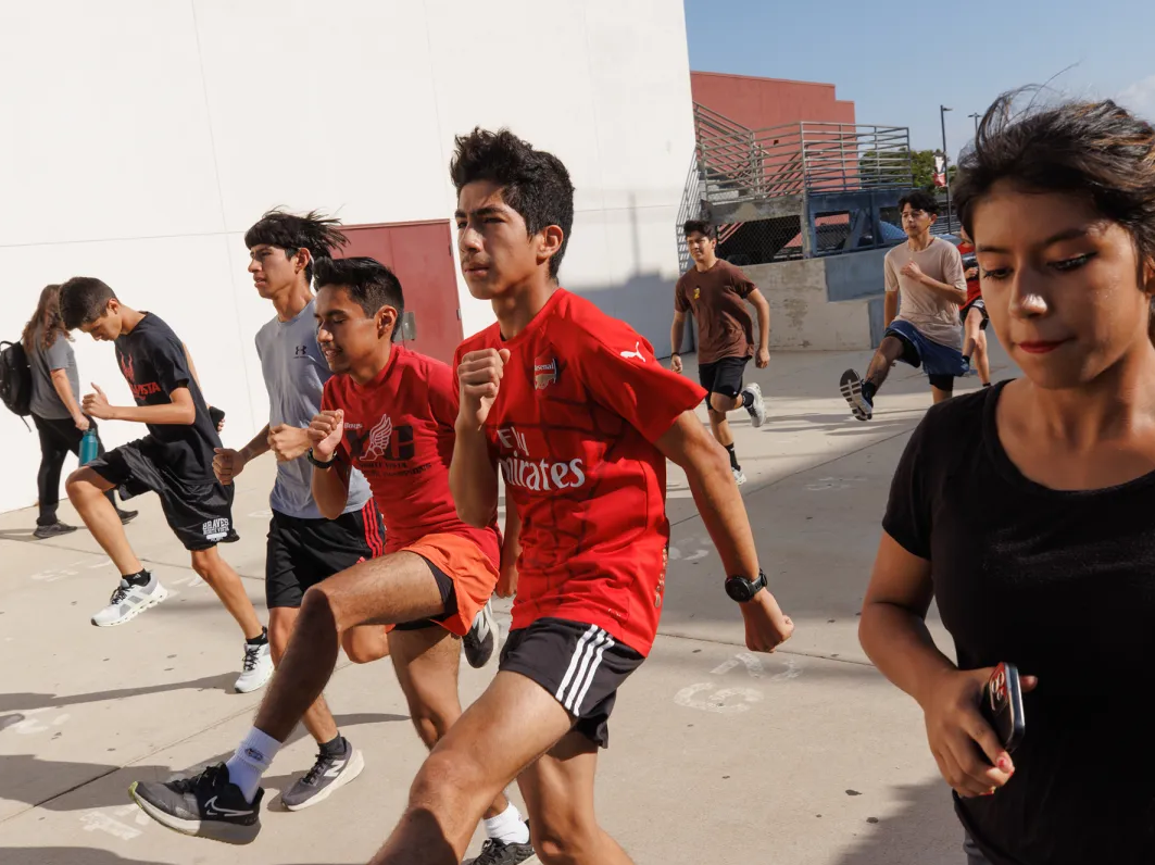 Students stretch before cross-country practice at Norte Vista High in Riverside on Sept. 19, 2024.