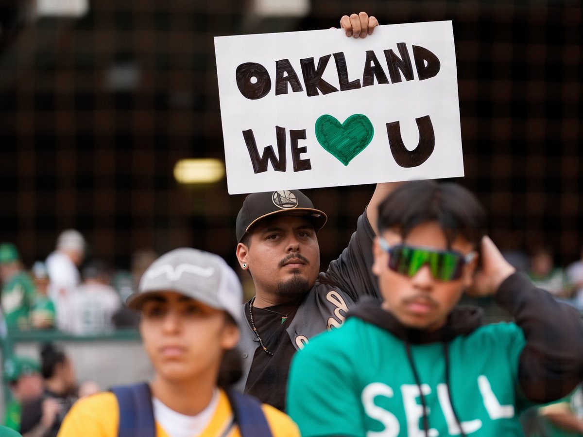 An Oakland Athletics fan holds up a sign before a baseball game against the Texas Rangers, Thursday, Sept. 26, 2024, in Oakland, Calif.