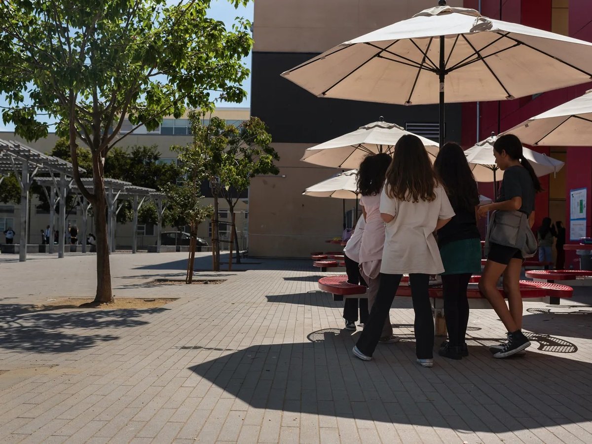 Students play in the shade during recess in the schoolyard of La Escuelita Elementary School in Oakland, on Sept. 23, 2024. Many California schools have no functioning air conditioning.
