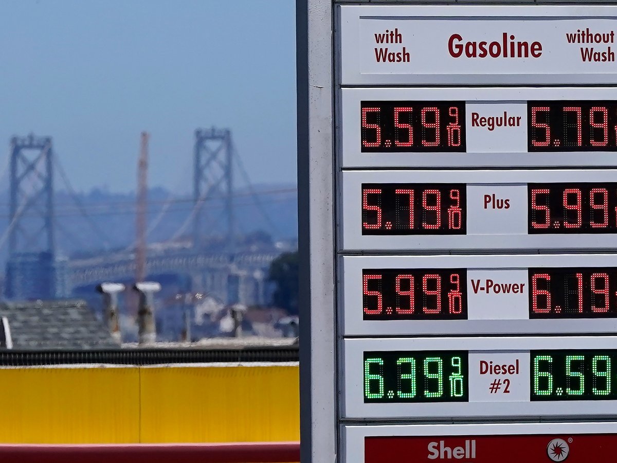 The San Francisco-Oakland Bay Bridge rises behind the price board of a gas station in San Francisco on July 20, 2022.