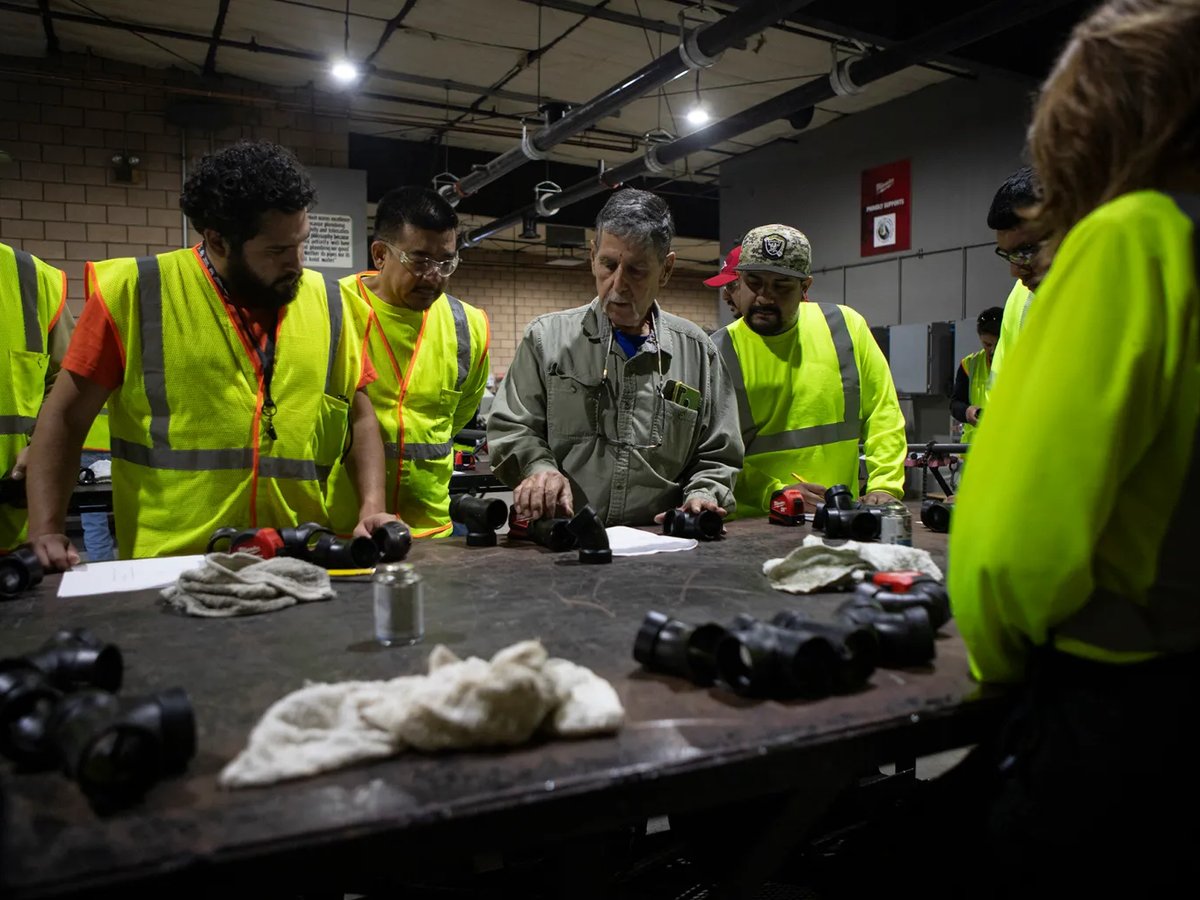 Instructor Tony Flores shows students in the ValleyBuild program how to measure and cut a pipe during a lesson in a workshop at the Fresno Area Pipe Trades Training Center in Fresno on Oct. 28, 2024.