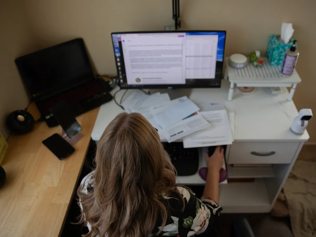 Kim Tanner, a marketing consultant, sits in front of her computer at home in Carlsbad on Oct. 11, 2024.