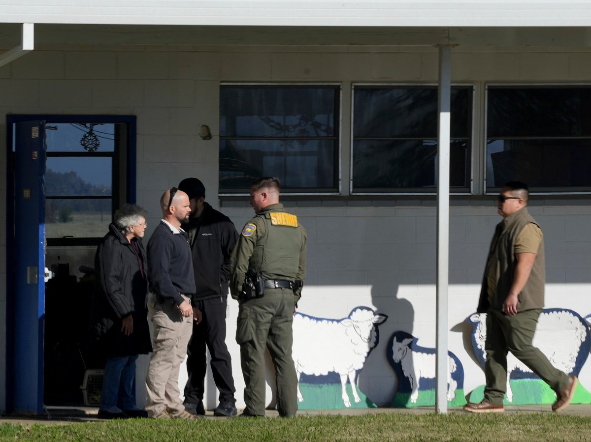 School officials and Sheriff's deputies gather outside Feather River Adventist School after the previous day's shooting on Thursday, Dec. 5, 2024, in Oroville, Calif.