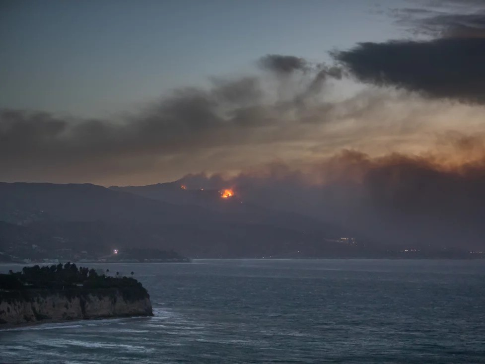 Smoke from the Palisades Fire is seen from Point Dume while it burns homes along the Pacific Coast Highway amid a powerful windstorm on Wednesday in Malibu, California.