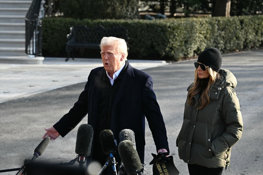 President Trump, shown here standing with first lady Melania Trump, speaks to reporters at the White House before leaving for his trip to North Carolina and California on Jan. 24.