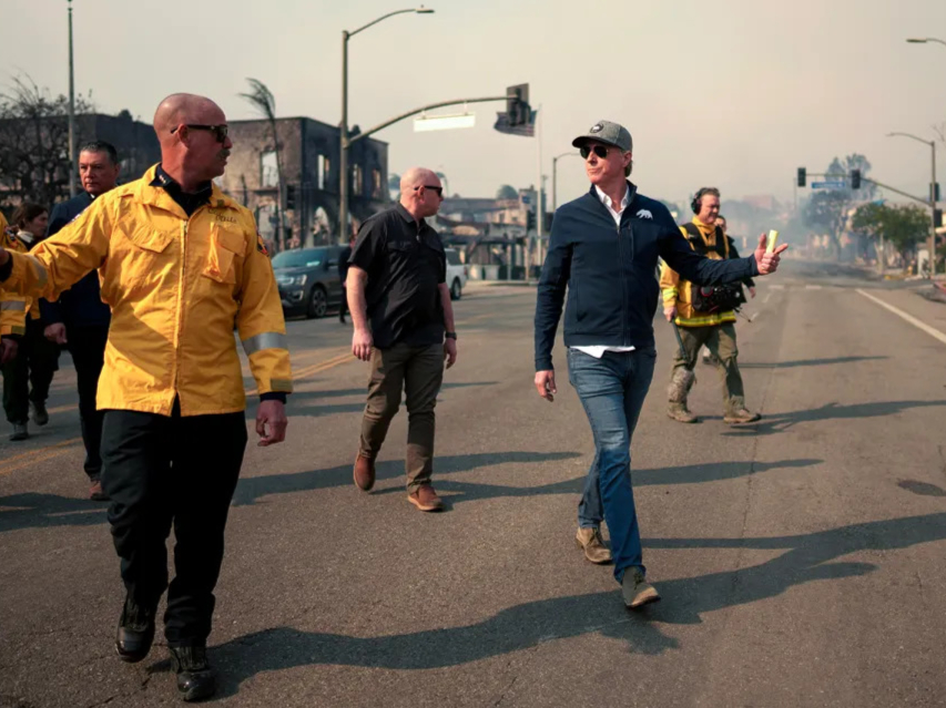 Gov. Gavin Newsom tours the downtown business district of Pacific Palisades as the Palisades Fire burned on Jan. 8, 2025. Today President Trump is due to arrive.