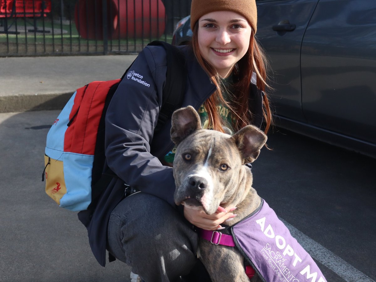 Abby Payne, the volunteer program coordinator poses with Missy the pit bull mix as she returns to the shelter Wednesday Feb. 13, 2025.