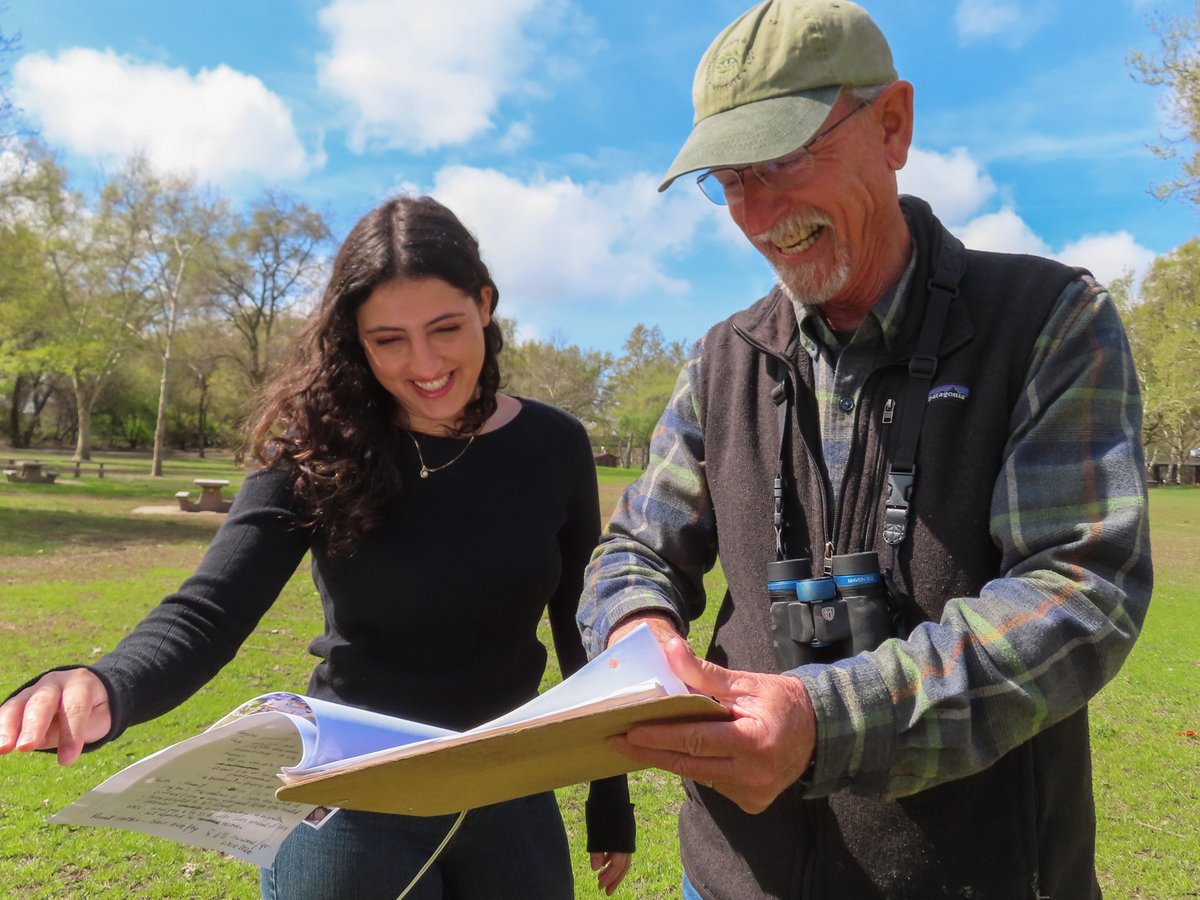 Dan Airola (right) and his daughter, Layla, go through notes on the yellow-billed magpie Thursday, March 20, 2025, at Discovery Park in Sacramento. He’s been tracking the birds since 2020.
