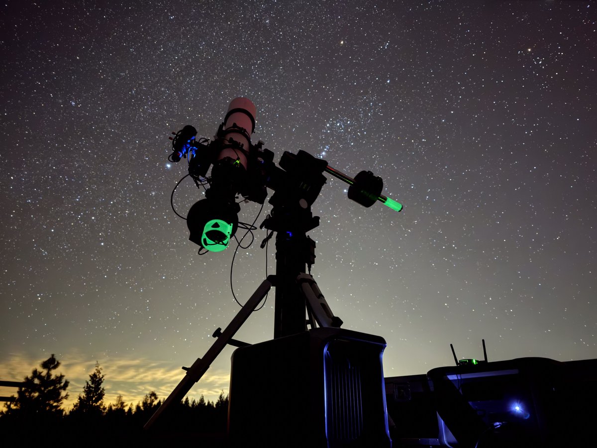 A photo of a telescope in front of the night sky.