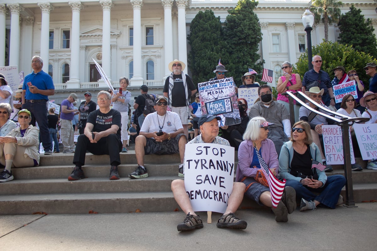 Sacramento protesters sit on the west steps of the Capitol Saturday, June 14, 2025.