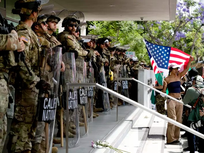 Protesters stand off against California National Guard soldiers at the Federal Building in downtown Los Angeles during a "No Kings" protest on Saturday.
