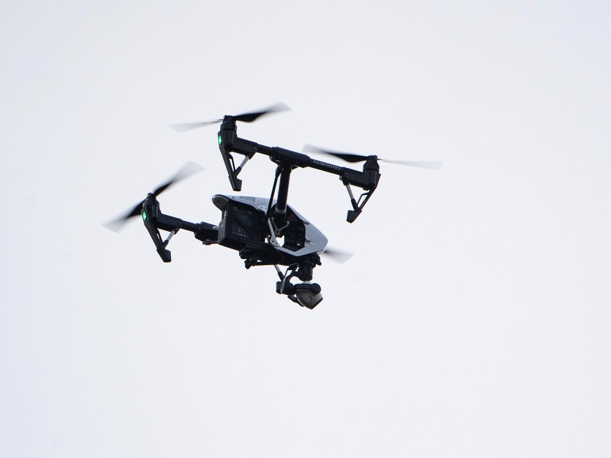 In this Thursday, Aug. 8, 2019, file photo, a drone flies in a residential neighborhood in Upper Moreland, Pa.