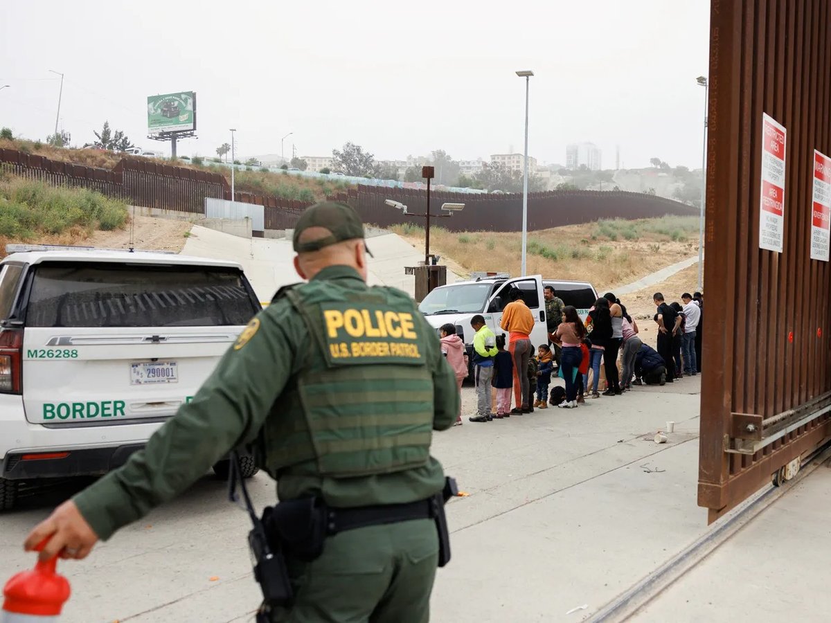 U.S. Border Patrol agents sort migrants who overnight gathered between the primary and secondary border walls that separate Mexico and the U.S. following the announcement of tough new restrictions imposed by U.S. President Biden. June 6, 2024.