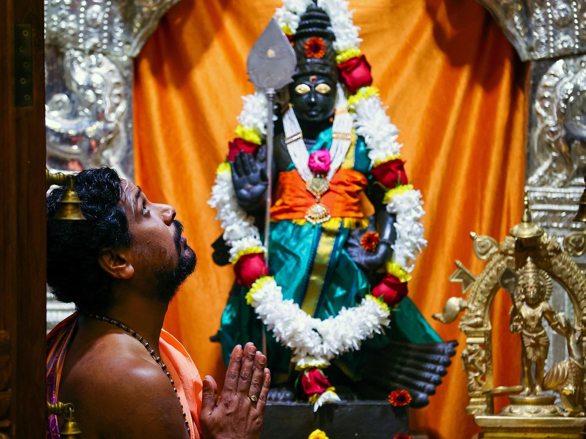 A priest prays inside a shire at the Karya Siddhi Hanuman Temple in Frisco, Texas, Oct. 22, 2022, as worshippers celebrated Dhanteras, which is the first night of the Hindu holiday Diwali.
