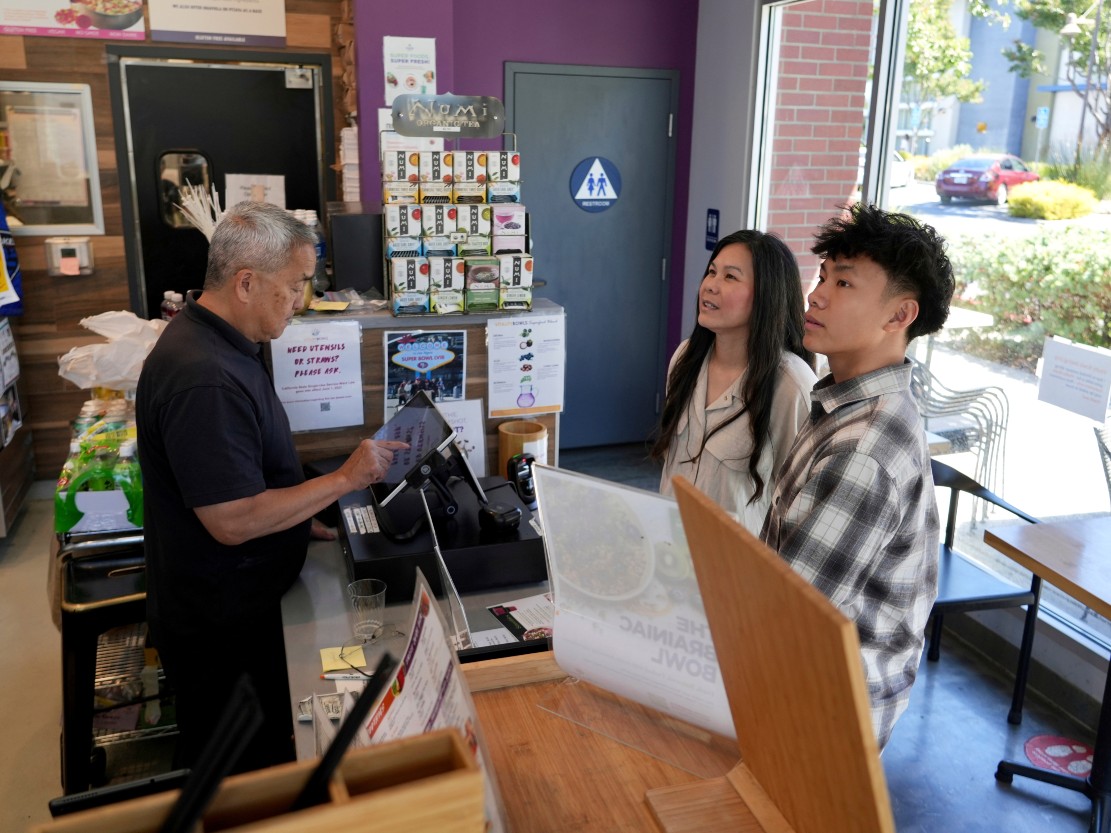 Braxton Kimura, right, orders food with his mother Carol Kimura at Vitality Bowl on Aug. 13, 2025, in San Jose, Calif.