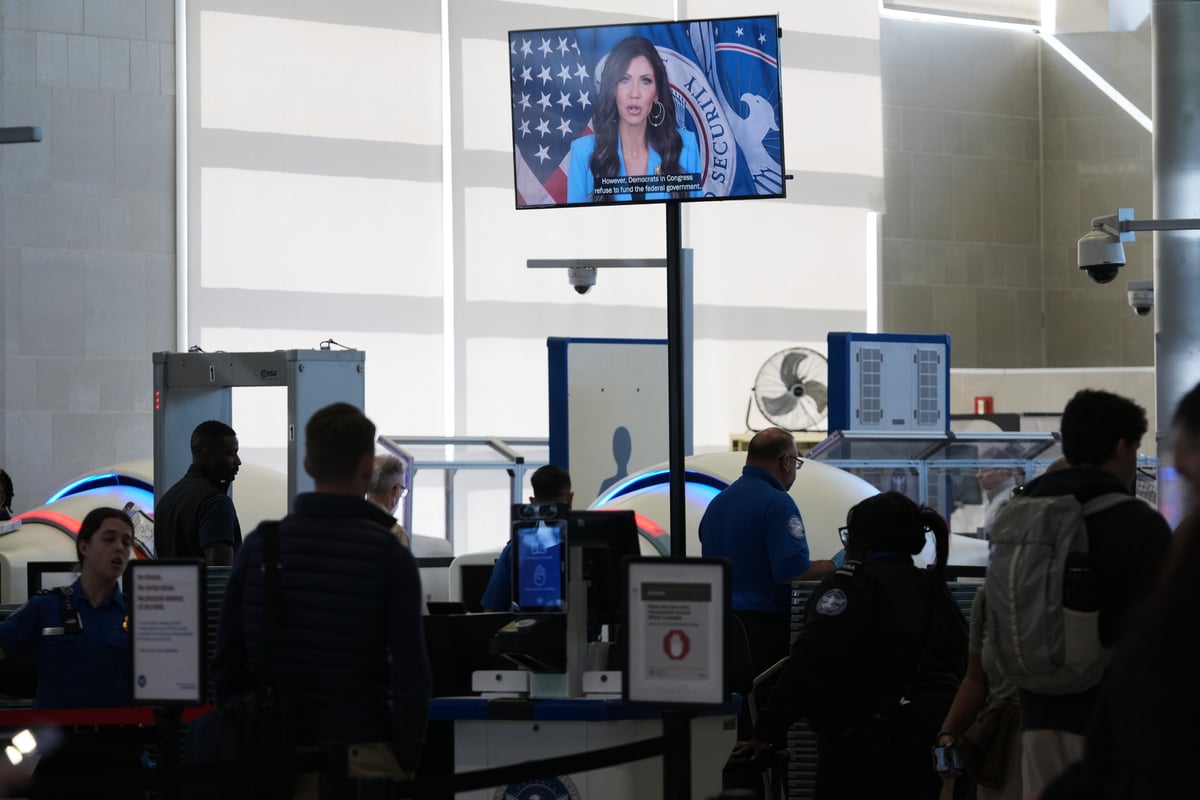 A video shows Homeland Security Secretary Kristi Noem speaking as TSA agents check passengers at Detroit Metropolitan Wayne County Airport Thursday, Oct. 16, 2025, in Romulus, Mich.