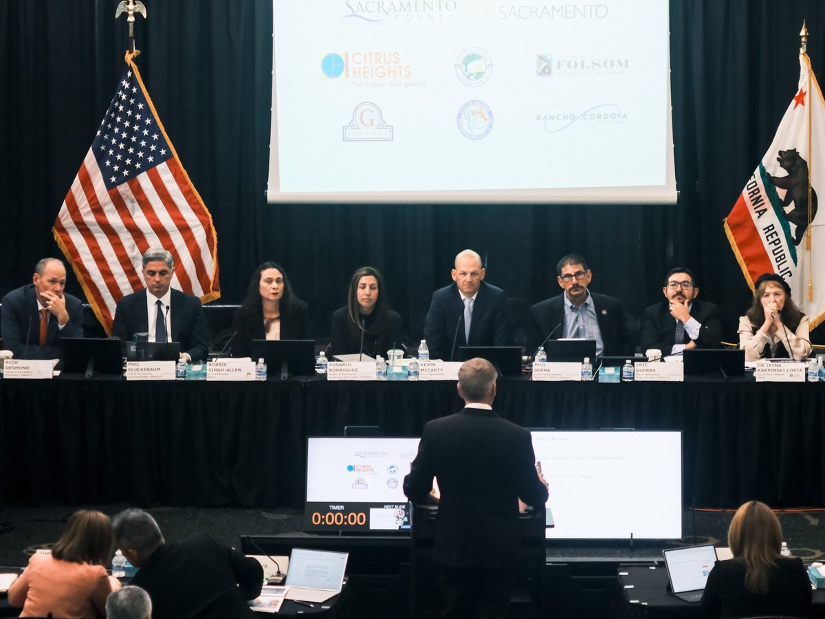 Sacramento Mayor Kevin McCarty (center) flanked by local and regional elected officials at a joint meeting on homelessness. Oct. 28, 2025.