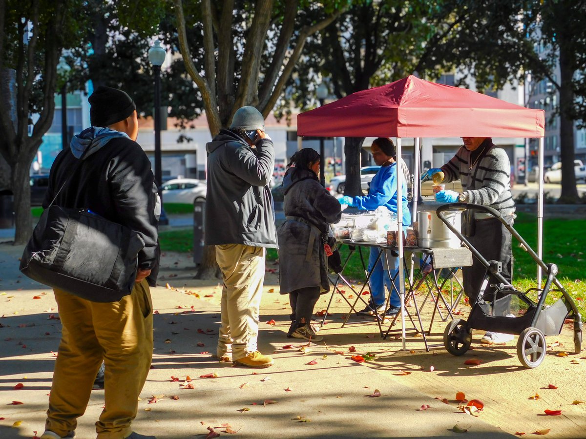 Ken Diggs serves hot soup and sandwiches to unhoused residents at César Chávez Plaza on Tuesday, Dec. 2, 2025.