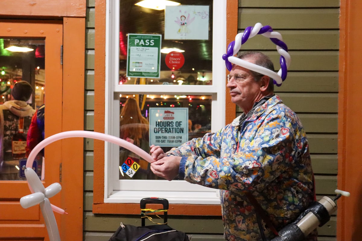 Roy Ele twists balloon art outside Joe’s Crab Shack in Old Sacramento on Jan. 10, 2026. Ele is a longtime balloon artist and substitute teacher.